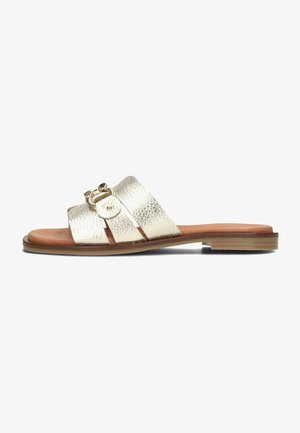 Gold metallic slide sandal with textured straps, featuring a round buckle detail and a flat brown sole. Smooth finish and open design.
