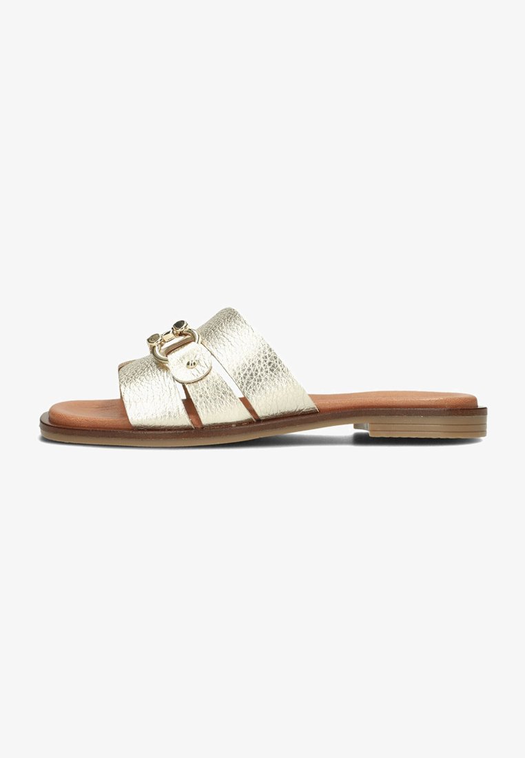 Gold metallic slide sandal with textured straps, featuring a round buckle detail and a flat brown sole. Smooth finish and open design.