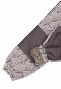 Steppjacke mit Blumenmuster in Grau- und Beigetönen, elastischen Bündchen und einer aufgerollten Stoffdetail am Ärmel. Strukturierter Stoff mit weicher Oberfl�äche.