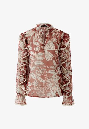 Transparante blouse met lange mouwen, rood-wit bloemmotief, gerimpelde mouwen, hoge hals en sluiting met strik en pomponaccenten.