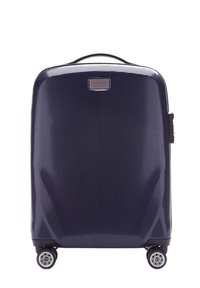 Valise rigide de couleur bleu marine avec une surface texturée, quatre roues et une poignée sur le dessus. Présente une forme rectangulaire et un accent de logo.