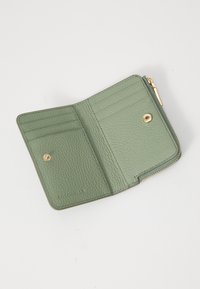 Green leather wallet with a textured finish, featuring multiple card slots, and a zippered compartment, accented with gold hardware.
