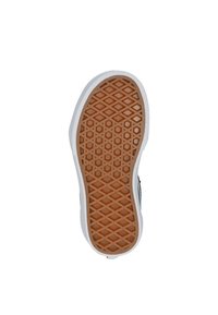 Suela de zapato con un fondo de goma marrón claro con un patrón de diamante, bordeada por un borde de goma blanca. La superficie superior es negra.