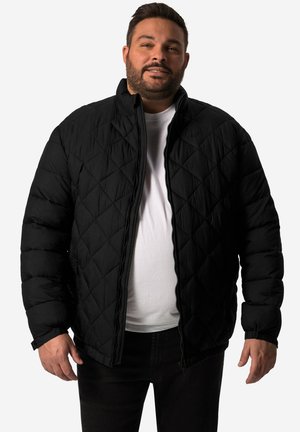 Schwarze gesteppte Daunenjacke mit hohem Kragen, Reißverschluss und elastischen Bündchen, getragen über einem weißen Hemd mit strukturiertem Finish.