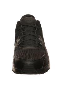 Black athletic shoe featuring a mesh upper, smooth leather accents, sturdy laces, and a textured sole for traction.