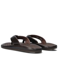 Des tongs marron avec une tige en cuir lisse, un coussinet en dessous du pied et une semelle en caoutchouc texturée avec un motif.