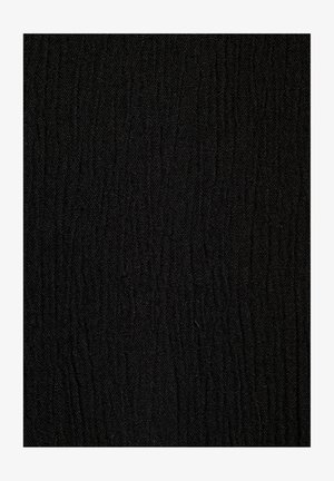 Tessuto nero testurizzato con un fine motivo ondulato. La superficie è liscia ma presenta una sottile qualità dimensionale.