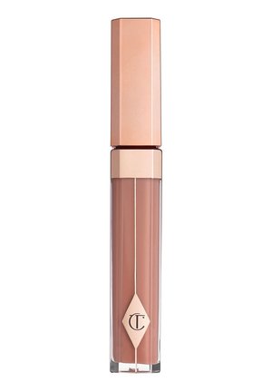 Rossetto liquido nudo in un tubo trasparente con un cappuccio esagonale dorato e rosa dorato, caratterizzato da un logo a forma di diamante sul lato anteriore.