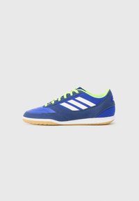 Blue athletic shoe featuring a mesh upper with white stripes, green laces, and a gum rubber sole, designed for indoor sports.