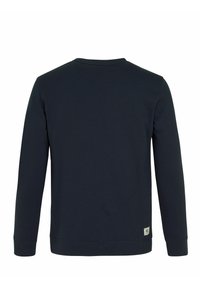 Sweatshirt bleu marine à manches longues et col rond. Fabriqué en tissu doux, il présente une petite étiquette de logo sur le bas à gauche.