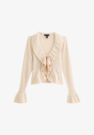 Beige knitted cardigan with a large collar, bow detail at the front, and flared cuffs. Textured pattern throughout the fabric.