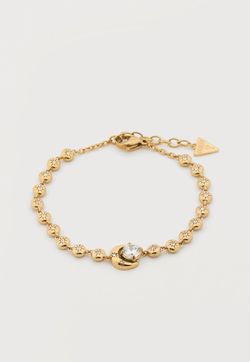 Βραχιόλι με αλυσίδα σε χρυσή απόχρωση, μικρές χάντρες χαραγμένες με αστέρια, κόσμημα από ημισέληνο που κρατά μια στρογγυλή διαφανή πέτρα και κούμπωμα σε σχήμα αστακού με ταμπελάκι.