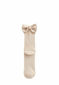 Beige Rippensocken mit einer Satin-Schleife am Bund. Das Material ist weich und hat eine glatte Textur, ideal für die Freizeit.