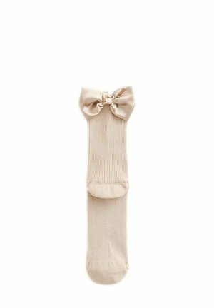 Beige Rippensocken mit einer Satin-Schleife am Bund. Das Material ist weich und hat eine glatte Textur, ideal für die Freizeit.