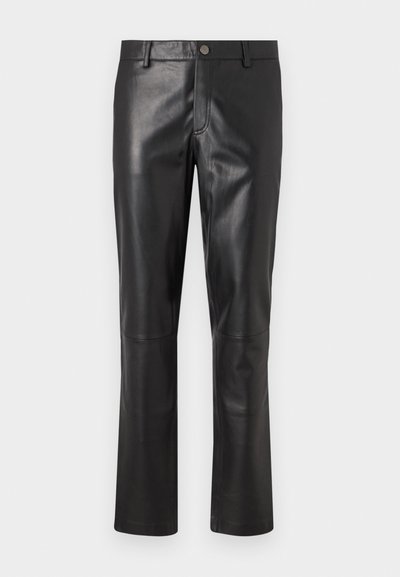 Čierne kožené nohavice s hladkou textúrou, rovnými nohavicami a jemným prešívaním pozdĺž švov. Vybavené zapínaním na gombík v páse.