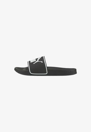 Black slide sandal with white piping and Puma logo. Made of synthetic material, featuring a textured strap and flat sole.