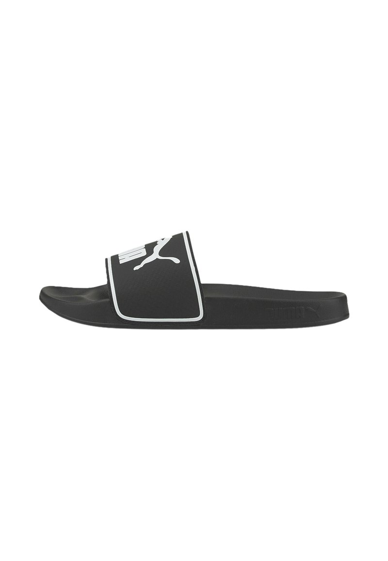 Mule noire avec un piping blanc et le logo Puma. Fabriqué en matériau synthétique, avec une sangle texturée et une semelle plate.