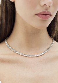 Silver-tone necklace featuring rectangular clear crystals set in a delicate metal chain, highlighting a sleek and modern design.