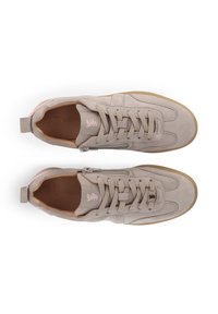 Beige suede sneakers with a textured surface, round toe, pink accents, and a side zipper. Rubber sole with a tan color.
