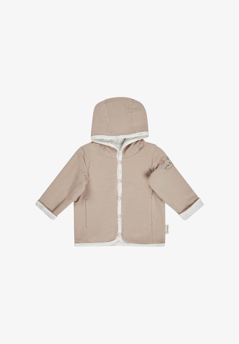 Béige Kapuzenjacke mit Druckknopfverschlüssen, weißen Akzenten und einer Katzenillustration auf dem Ärmel. Weicher Stoff mit einer glatten Textur.