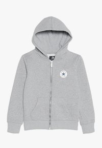 Grijze zip-up hoodie met een trekkoordkap, ribgebreide boorden en zoom, buidelzakken en een ronde logo-patch op de linkerborst.