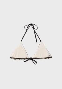 Haut de bikini triangle blanc avec bordure noire et liens ajustables autour du cou et du dos sur un fond clair uni.