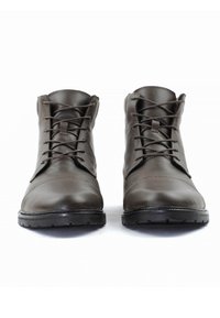 Braune Leder-Ankle-Boots mit sauberem Nähen, Schnürdesign, runden Zehen und strukturierten schwarzen Gummisohlen.