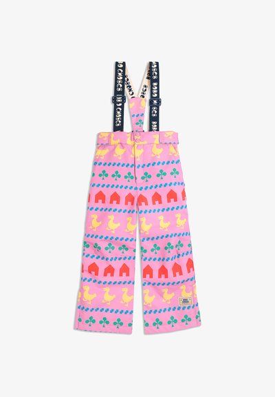 Pink pants with yellow ducks and red houses pattern, featuring adjustable navy suspenders with white text. Made from soft fabric.