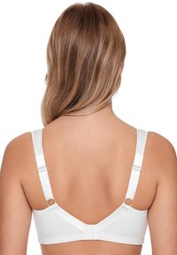 White bra with adjustable straps and silver hardware. Smooth fabric, simple design, features a hook closure and minimal stitching details.
