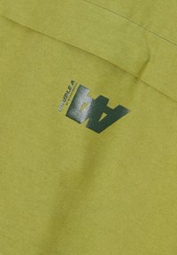 Green fabric features a smooth texture with a diagonal weave. It displays a black printed logo reading "DOUBLE A" with a stylized "4" design.