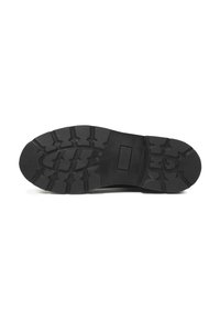 Semelle en caoutchouc noir dotée d'un motif texturé offrant une adhérence, avec un design plat et des bords lisses pour plus de stabilité.