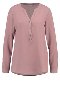 Blouse rose à manches longues avec un tissu texturé. Elle présente une patte de boutonnage avec un ourlet arrondi et une coupe légèrement ample.
