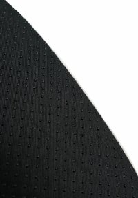 Black textured fabric with a raised dot pattern, showing a smooth surface and slight sheen, angled to display its depth and design.