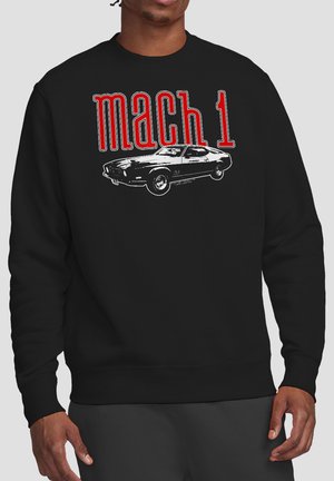 Black sweatshirt with red text "mach 1" and a grayscale vintage muscle car graphic on the chest, worn by a standing person.
