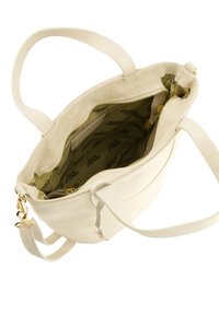 Beige tote taske med en tekstureret ruskindsudvendig, en glat læderrem og et mønstret foer. Har en lynlåslukning og en indvendig lomme.