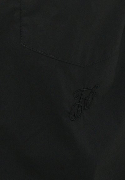 Black fabric with a smooth texture, featuring a subtle embroidered logo in a matching black thread on the lower right section.