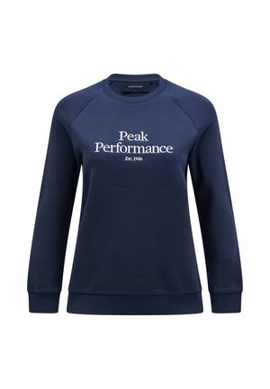 Sweatshirt bleu marine en tissu doux, avec un col rond, des poignets et un ourlet côtelés, orné de texte blanc indiquant "Peak Performance Est. 1986."