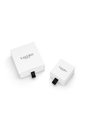 Bele škatle za nakit, ena večja in ena manjša, obe s črnim trakom za poteg in vtisnjenim logotipom "VALERO PEARLS" na vrhu.