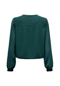 Blusa verde texturizada con mangas largas, con parte trasera fruncida y patrón de puntos en relieve. Corte holgado con puños elásticos.