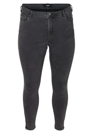 Sorte denim skinny jeans med tætsiddende pasform, frontlynlås og knaplukning. Har diskrete syninger og sidelynlåse ved anklerne.