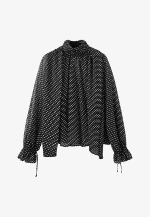 Blusa negra de manga larga con lunares blancos, cuello alto, corte holgado y puños fruncidos con lazos en las mangas.
