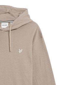 Beige bomullshuvtröja med dragsko i huvan, med en liten vit broderad logotyp på bröstet och en mjuk, texturerad yta.