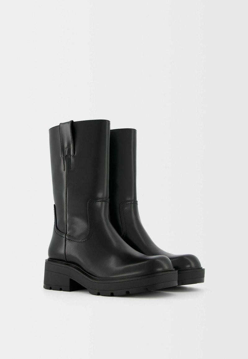 Stivali alla caviglia in pelle nera con finitura liscia, punta arrotondata, tacco a blocco, tagli laterali e linguetta posteriore per una facile calzata.