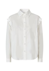 Camicia bianca con bottoni, realizzata in cotone, con colletto classico, maniche lunghe e bottoni decorativi sulle spalle. Texture liscia.