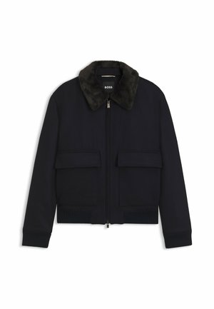 Black men's bomber jacket with faux fur collar, front zipper, and two flap pockets at waist. Ribbed cuffs and hem.