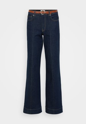 Dark blue denim flared jeans with a brown belt, featuring contrast stitching, two front pockets, and a cuffed hem.