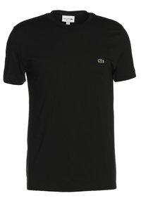 T-shirt en coton noir avec une coupe regular, des manches courtes, un col rond et un petit logo crocodile brodé en vert sur la poitrine gauche.