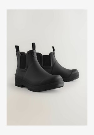 Ghete negre din cauciuc pentru gleznă, cu o textură netedă, panouri laterale elastice, șnururi pentru agățat și talpă robustă pentru aderență. Design ușor și impermeabil.