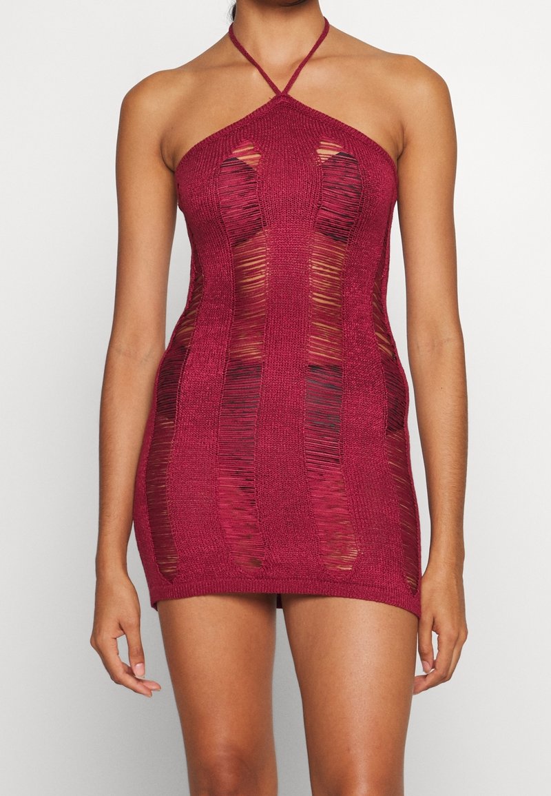 Virkat halterminiklänning i burgundy med skärningar, med öppna vävningar och en figurnära design. Justerbar nackrem.