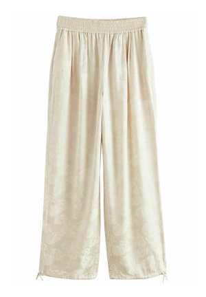 Pantaloni larghi di un beige chiaro con vita elastica, caratterizzati da un leggero motivo floreale, una texture morbida e un dettaglio legato all'orlo.